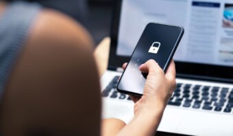 Una mujer que usa un teléfono inteligente con un candado para evitar fraudes.