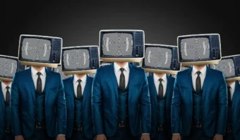 Un grupo llamado Los Peñabots, vestidos con trajes azules y con televisores viejos que muestran patrones en espiral como cabezas, se encuentran en filas contra un fondo oscuro.